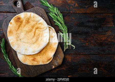 Pita flat bread set, on old dark wooden table background, top view flat lay, with copy space for text Stock Photo