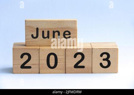 June 2023 text on wooden blocks with white color background. Copy space and month concept