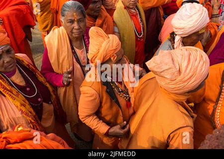 Sadhvi in orange red saree during Allahabad Kumbh Mela, World’s largest religious gathering, Uttar Pradesh, India Stock Photo