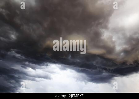 Dark storm clouds before rain, with strange cloud shapes. Storm clouds formed during the rainy season. Stock Photo