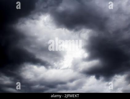 Dark storm clouds before rain, with strange cloud shapes. Storm clouds formed during the rainy season. Stock Photo