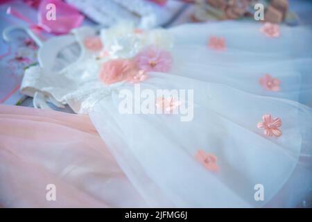 Baptism pictures. White gown baby with pink flowers outfit for religious celebration after birth. High quality photo Stock Photo