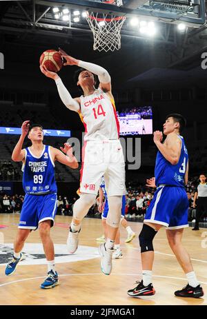 Melbourne, Australia. 4th July, 2022. Wang Zhelin (top) of China goes for a lay-up during a Group B match between China and Chinese Taipei of the FIBA World Cup Asian qualifiers in Melbourne, Australia, July 4, 2022. Credit: Bai Xue/Xinhua/Alamy Live News Stock Photo