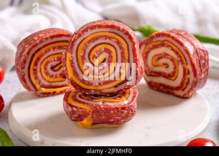 Grilled sausage made with sausage, cheddar cheese and pastrami on a stone floor. Meat specially prepared for barbecue. close up Stock Photo