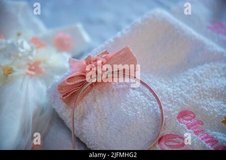 Baptism pictures. A pink baby girl tiara diadem for religious celebration after birth. High quality photo Stock Photo