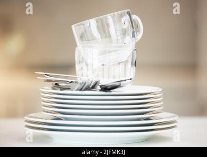 Closeup of a stack of clean dishes. Spotless pile of dishes straight out of the dishwasher. Closeup of a stack of clean dishes. Spotless pile of Stock Photo