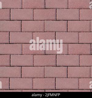 Background of seamless texture of masonry road made of dark pink brick. Top view Stock Photo