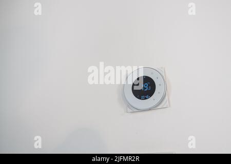 Temperature regulator for air conditioning and heating on the wal Stock Photo