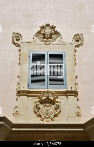 The window of an ancient house the historic center of Tricase, a medieval town in the Puglia region. Stock Photo