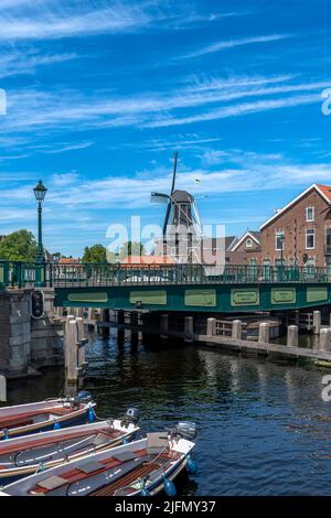 The iconic view of Holland with the Windmill De Adriaan. Plus canal-side living in the beautiful city of Haarlem, west of Amsterdam, The Netherlands. Stock Photo