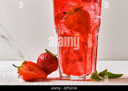 Stawberry drink with mint and ice on light background. Stock Photo