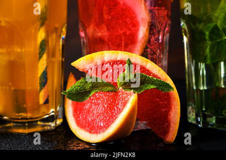 close-up of grapefruit and mint slices and Three classic cocktail glasses Stock Photo