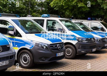 Magdeburg, Germany - June 6th, Row of many german police Mercedes and VW van cars parked at police station parking on sunny day. Civil emergency law Stock Photo