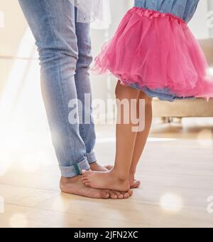 We all grow in different directions, but our roots remain. Shot of a father dancing with his daughter. Stock Photo