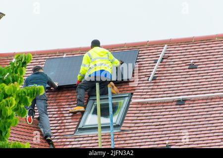 Installing solar panels on roof Stock Photo