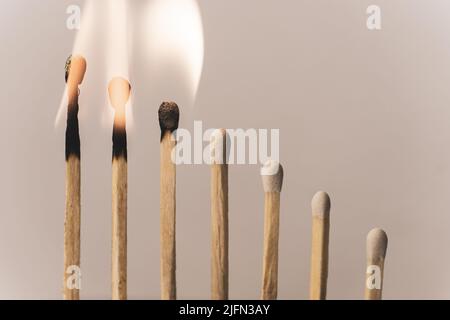 Matchsticks burning in sequence. Stock Photo