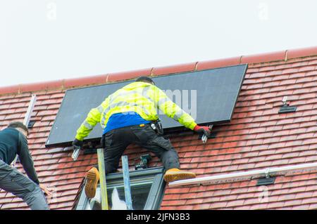 Installing solar panels on roof Stock Photo