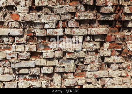 Old brick wall texture. The wall, made of old red bricks, darkened by old age. Ancient vintage brick wall background. Brick wall backdrop Stock Photo