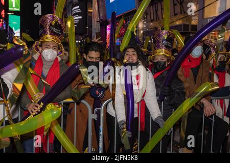 NEW YORK, N.Y. – December 31, 2021: New Year’s revelers are seen in Times Square. Stock Photo