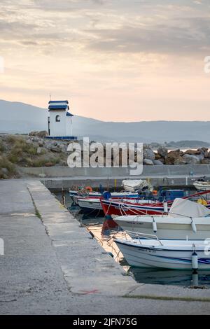Seascape scene with fishing boats and a little chapel in the background Stock Photo