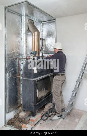 mounting on the walls of metal profile and mineral wool for thermal protection for walls, installation and repair work. Stock Photo