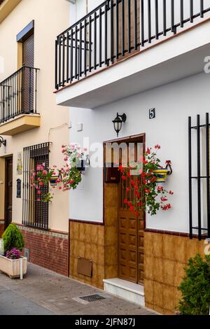 Streets of city of Alhaurin de la Tore, situated in south of Spain in Malaga province. Typically Andalusian small streets with white houses and flower Stock Photo