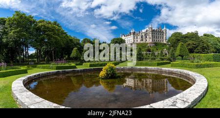 Golspie, United Kingdom - 25 June, 2022: view of Dunrobin Castle and Gardens in the Scottish Highlands and castle reflection in the fountain Stock Photo