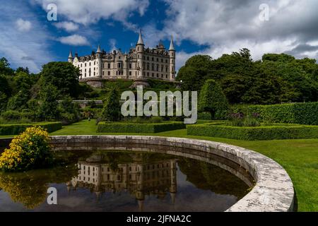 Golspie, United Kingdom - 25 June, 2022: view of Dunrobin Castle and Gardens in the Scottish Highlands and castle reflection in the fountain Stock Photo