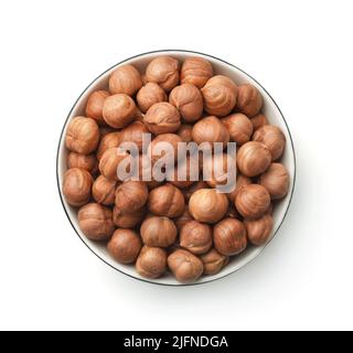 Top view of shelled hazelnut kernels in ceramic bowl isolated on white Stock Photo