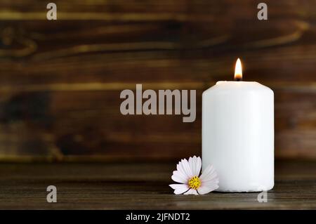 Condolence card with white burning candle and flower Stock Photo