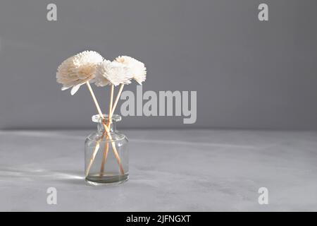 Aromatic reed air freshener on marble table background. Hygge, cozy concept Stock Photo