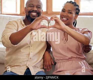Smiling young african american husband and wife hugging, looking at ...