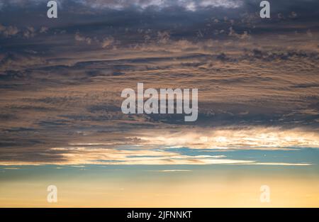 Detailed image of a textured pastel colored sky in the golden hour before sunset Stock Photo