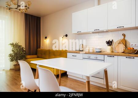 Mockup, empty table in bright kitchen interior. Copy paste for your design Stock Photo