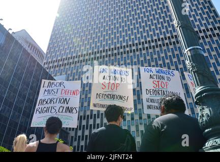 Activists hold signs in front of 26 Federal Plaza in New York City to demand reproductive rights for all Immigrants, on July 4, 2022. Stock Photo