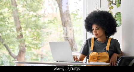 Happy young woman learning online, remote working in office. Stock Photo
