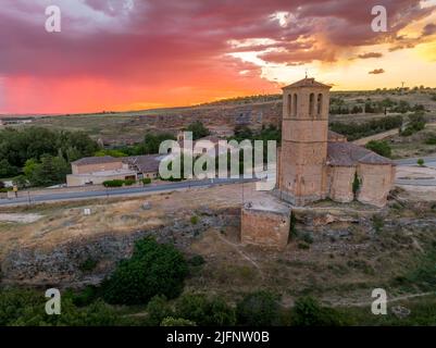 Gorgeous sunset with colorful sky above Segovia Alcazar and Iglesia de la vera cruz  Romanesque church in Spain Stock Photo