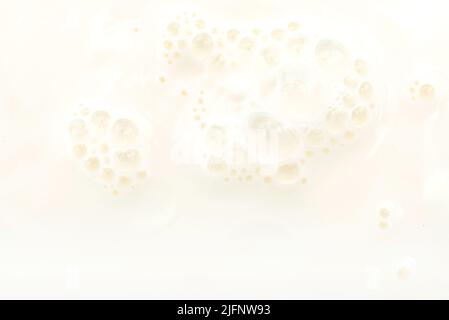 Texture or background from milk with bubbles close up. Milk Stock Photo