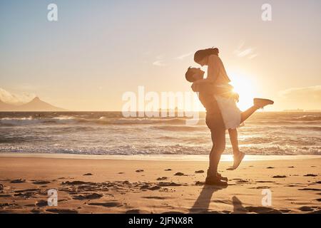 Young diverse biracial couple having fun at the beach together. Young diverse biracial couple having fun at the beach together. Stock Photo