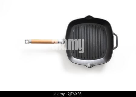 Empty cast iron grill pan with handle isolated on white background. Stock Photo