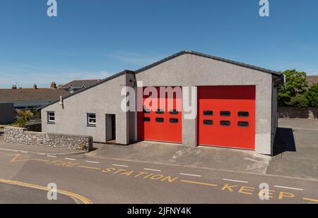 St Just, Cornwall, England, UK. 2022. A community fire station with double red up and over style doors. Stock Photo