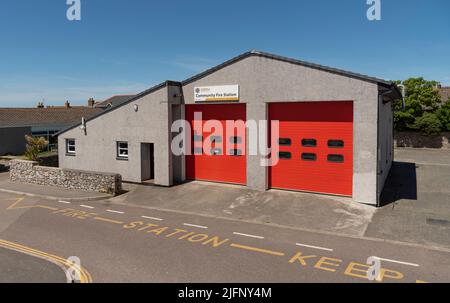 St Just, Cornwall, England, UK. 2022. A community fire station with double red up and over style doors. Stock Photo