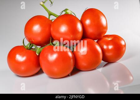 Tomatoes cut out tomatoes on vine - red ripe tomato - tomatoes white background cutout tomatos Solanum lycopersicum Stock Photo