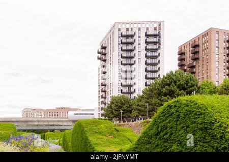 New block of modern apartments with balconies in grey sky in the background. Adjacent toThames Barrier Park, Silvertown Stock Photo