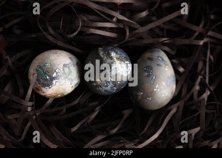 Marble blue Easter eggs ion a black background. Happy Easter holiday, top view, flat lay . Horizontal photo. Hibiscus eggs, naturally colored. Stock Photo