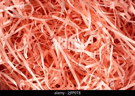 Texture Pink Spaghetti shredded packing paper. Paper used to protect fragile object while in transport, filling gift boxes and gift wrapping.  Stock Photo