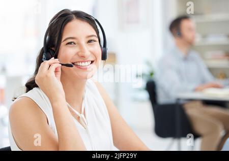 Your call is important to us. Portrait of a young call centre agent working in an office. Stock Photo