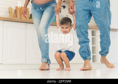 kid having fun with his parents in the kitchen family concept. High quality photo Stock Photo