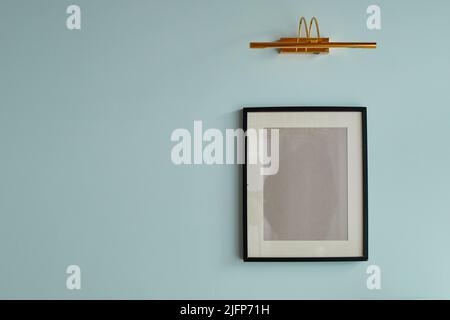 Minimal background image of graphic empty frame on pastel blue wall, picture mock up Stock Photo