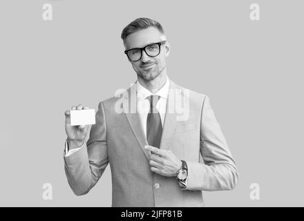 smiling mature man in glasses pointing finger on credit card and thumb up, copy space, call me Stock Photo